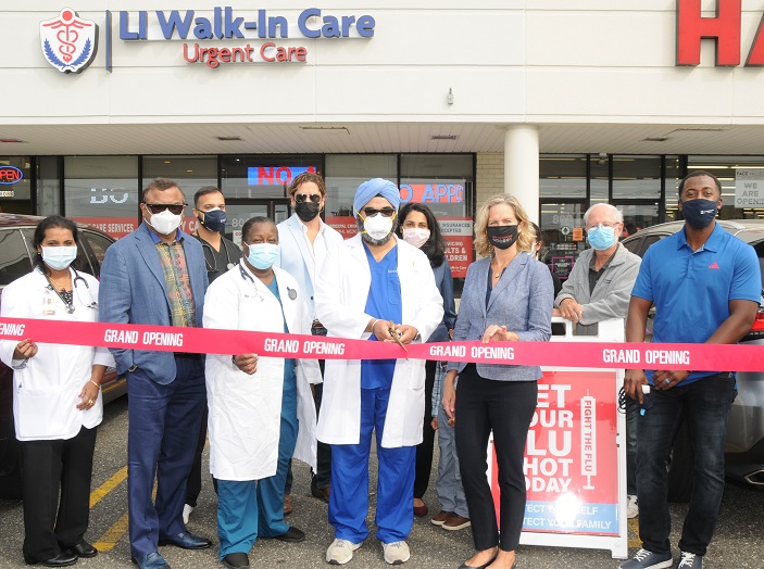 Nassau County Executive Laura Curran helps Dr. Inderpal Chhabra cut the ribbon on the new LI Walk-in Care Center